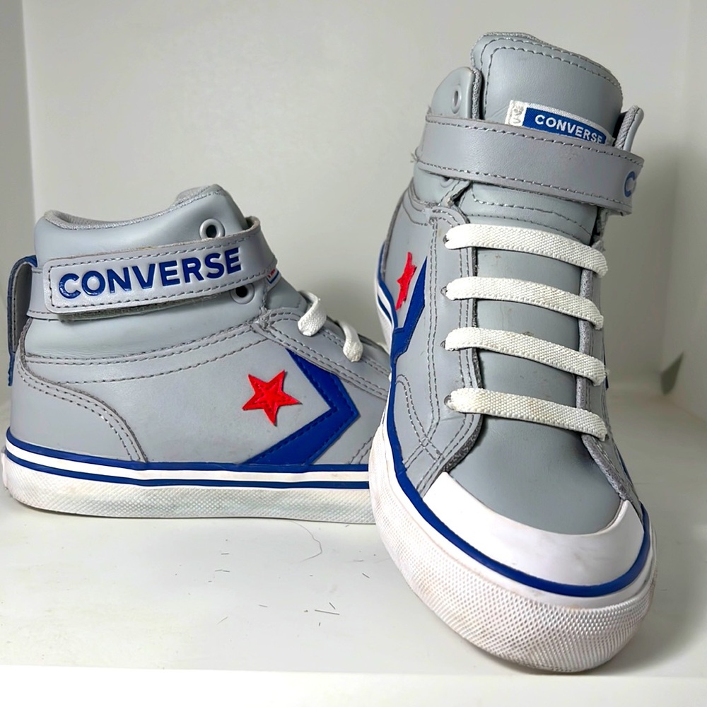 Girls Converse Junior Leather slip-on mid-tops.